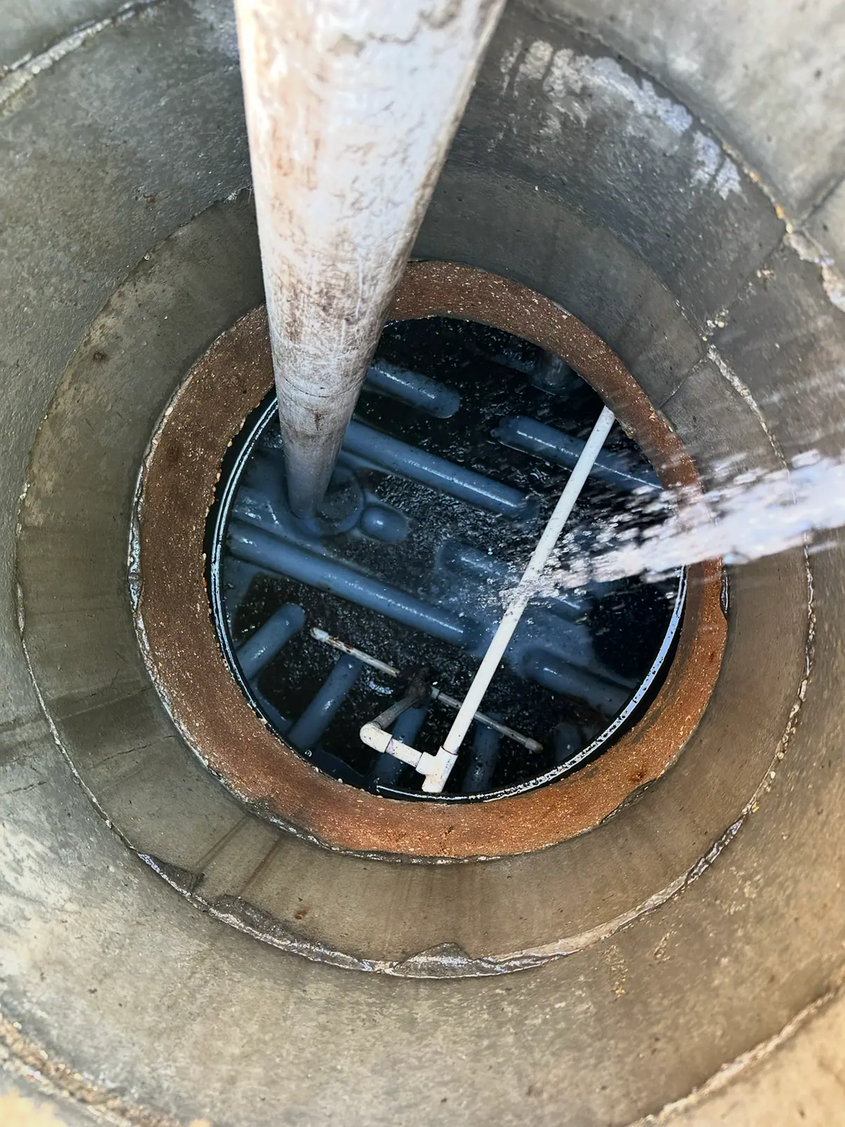 Water spraying inside a round concrete tank